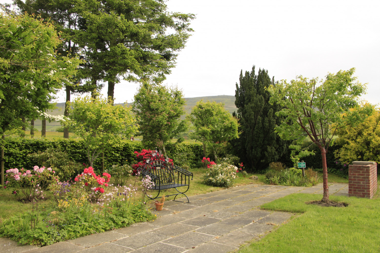 Front Garden with BBQ area.  Good sized grass area with a path all the way around and seating area