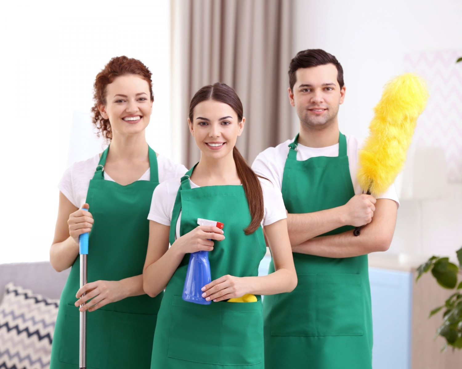 Stock photo of 2 women and a man with cleaning equipment